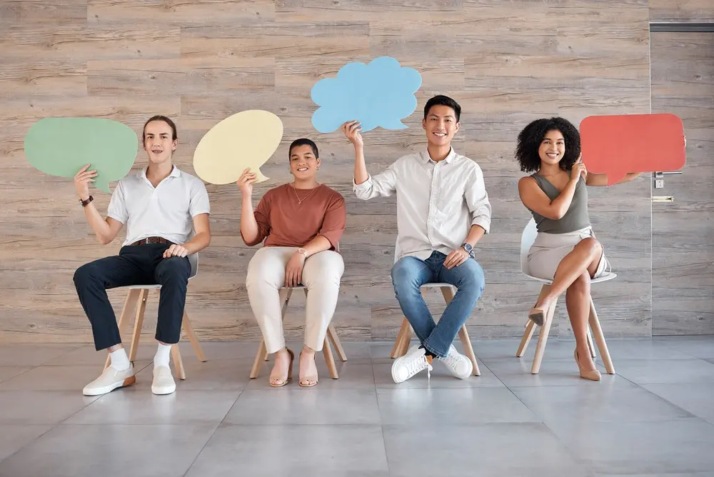 Young professionals holding speech bubbles